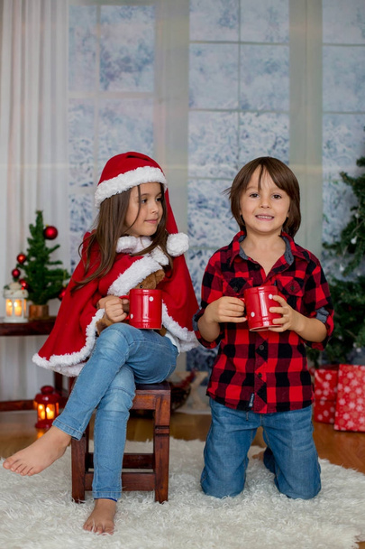Cute children, boy and girl, having fun on Christmas - Fotó, kép