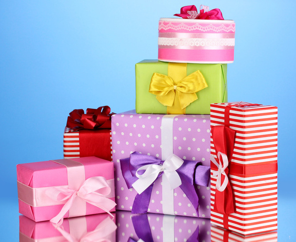 Colorful gifts on blue background - Foto, afbeelding
