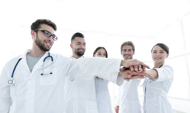 Doctors and nurses in a medical team stacking hands - Photo, image