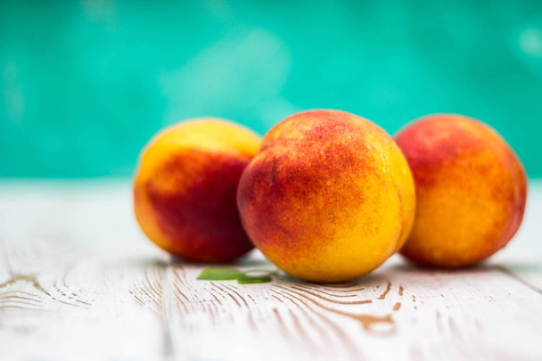 a lot of fresh peaches on a white table - 写真・画像