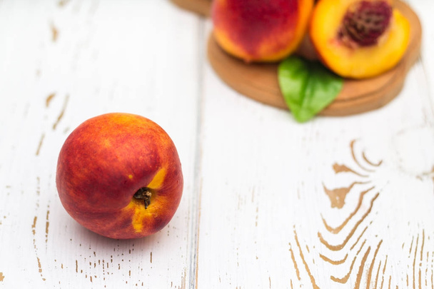 a lot of fresh peaches on a white table - Photo, image