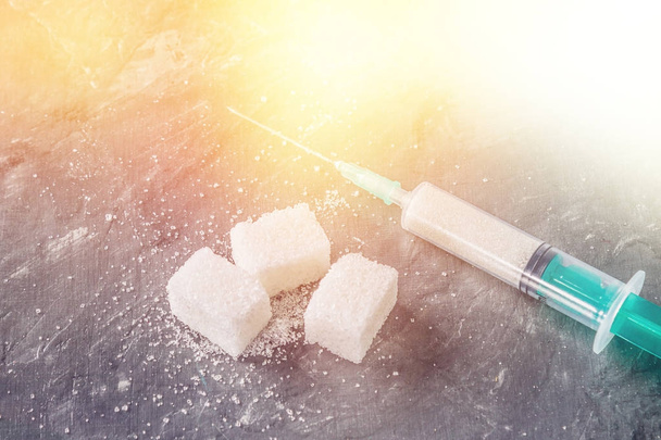 Sugar in a syringe. Conceptual depiction of dependence on the sweet. Sugar is a drug. Injection of sweets. - Zdjęcie, obraz