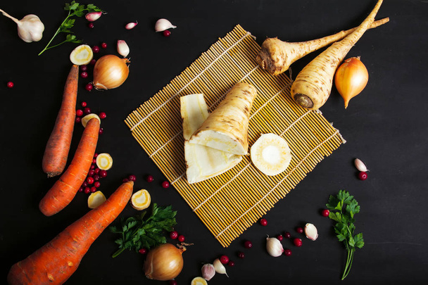 parsnip, carrots, onion, garlic, vegetables, on a black background - 写真・画像