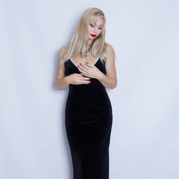 Beautiful blonde woman in black evening dress  - Valokuva, kuva