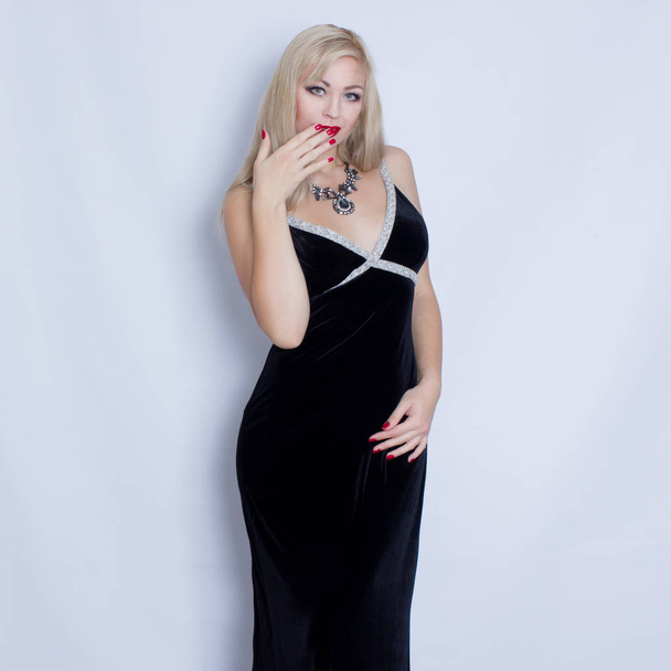 Beautiful blonde woman in black evening dress  - Fotó, kép