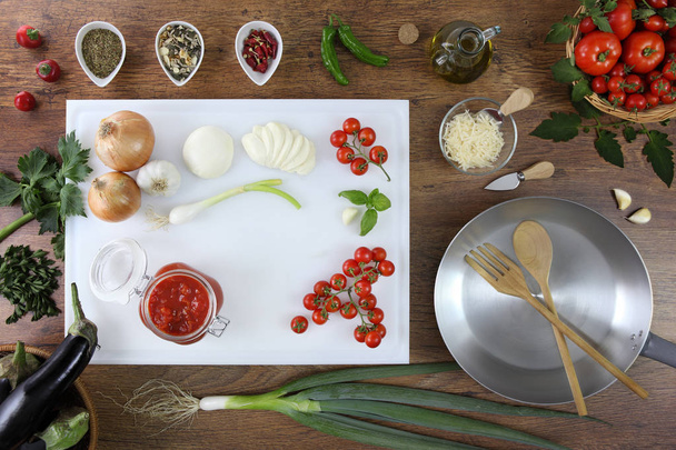 food top view, tomatoes sauce in glass jar on white cutting board - Foto, imagen