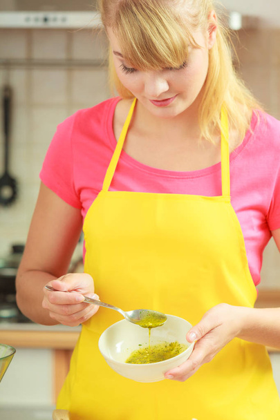 Woman preparing fresh salad dressing - Fotoğraf, Görsel