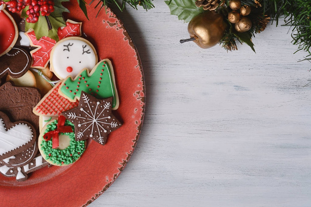 Red plate with colorful christmas cookies - Photo, Image