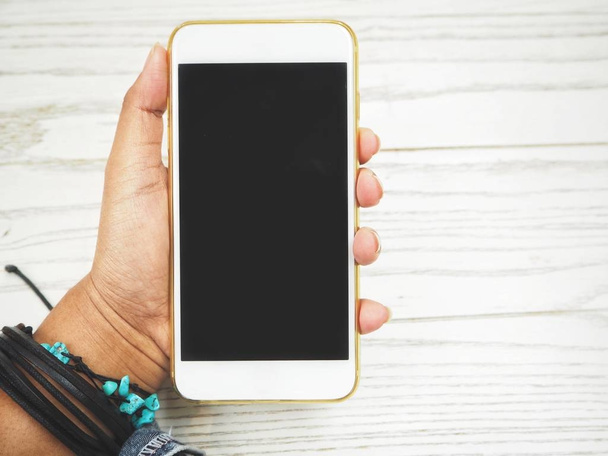 Smart phone on white wood background - Photo, Image