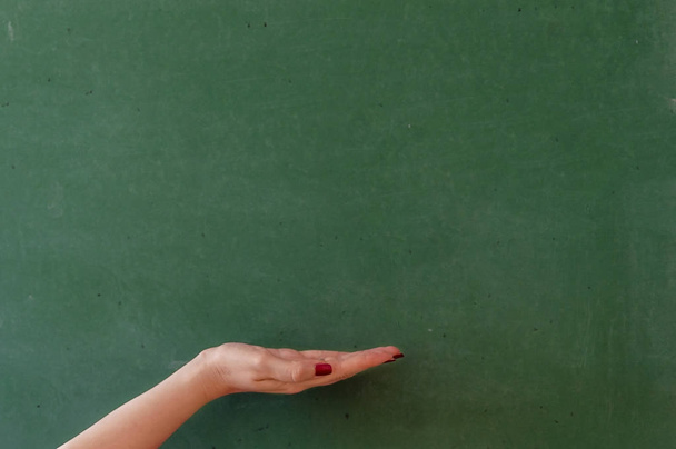 Clean chalkboard with hand and copyspace - Photo, Image