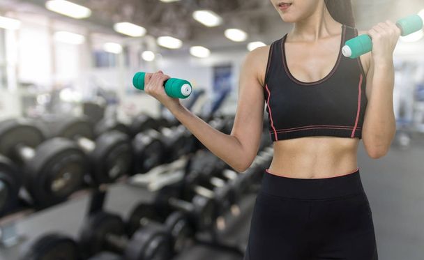 Young woman working out with dumbbells  - Photo, Image