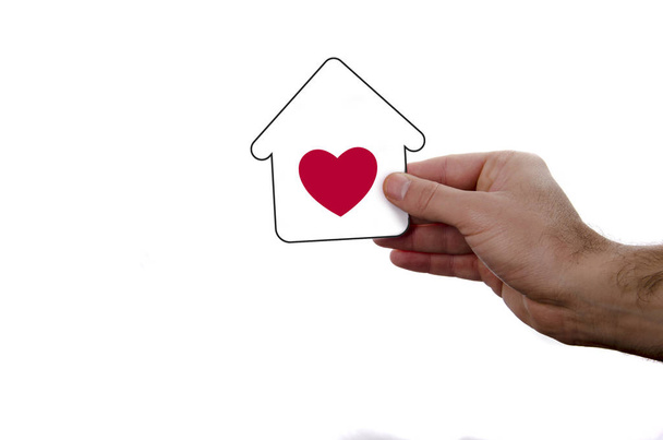 isolated hand holding dream house icon with red heart over a whi - Photo, Image