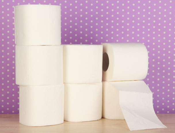 Rolls of toilet paper on purple with dots background - Foto, immagini
