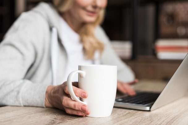 woman with coffee using laptop  - Фото, изображение