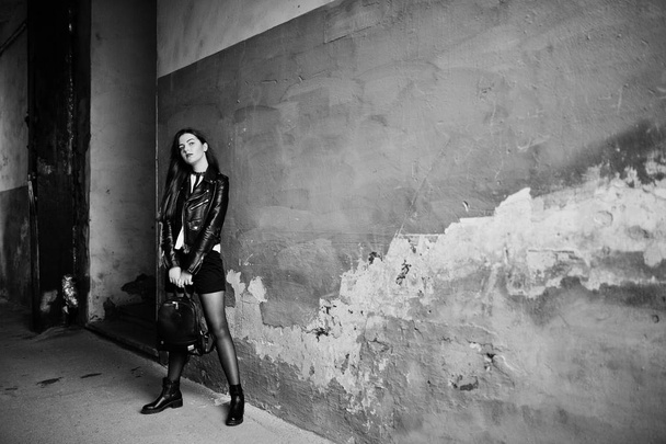 Stylish brunette girl wear on leather jacket and shorts with bac - Fotoğraf, Görsel