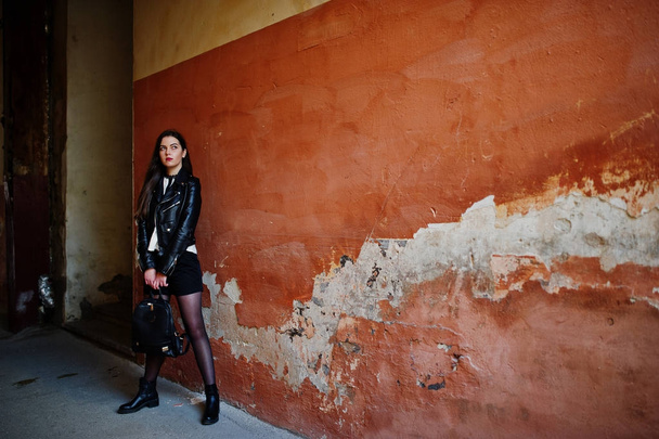 Stylish brunette girl wear on leather jacket and shorts with bac - Zdjęcie, obraz