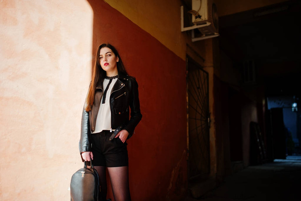 Stylish brunette girl wear on leather jacket and shorts with bac - Fotó, kép