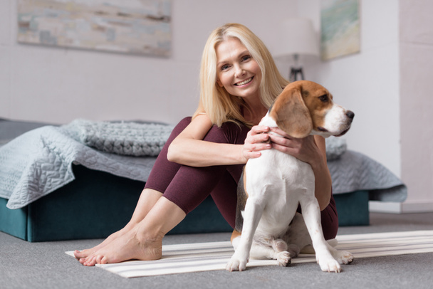 Woman with dog at home - Photo, Image
