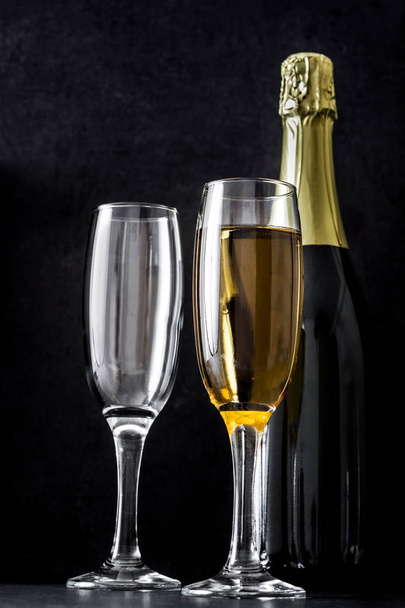 Champagne bottle and glasses on black background - Foto, Imagem