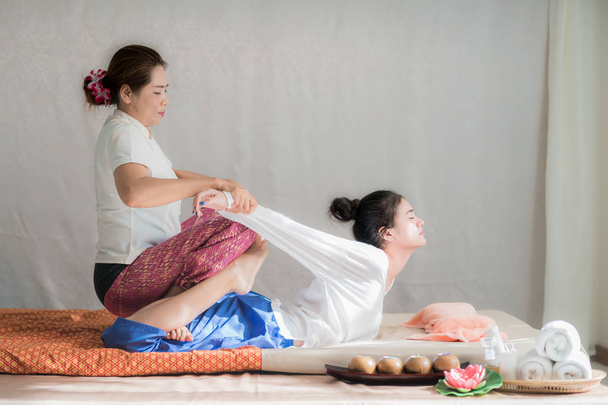 Thai masseuse doing spa massage for Young Asian woman in spa sal - Photo, Image