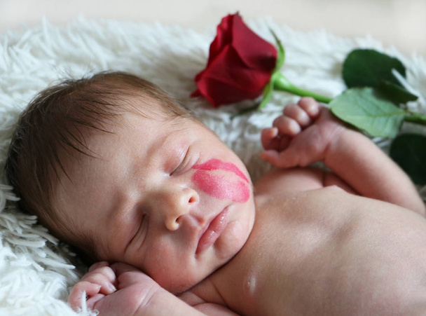 Portrait of cute sleeping newborn baby with kiss mark on the fac - Photo, Image
