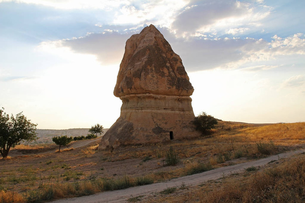 Natural valley with volcanic tuff stone rocks in Goreme in Cappadocia, Turkey, at sunset. - 写真・画像
