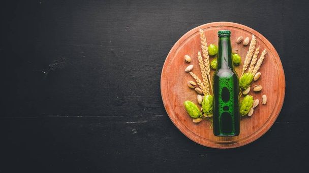 A bottle of beer, hops and grain. Top view. Free space for text. - Zdjęcie, obraz