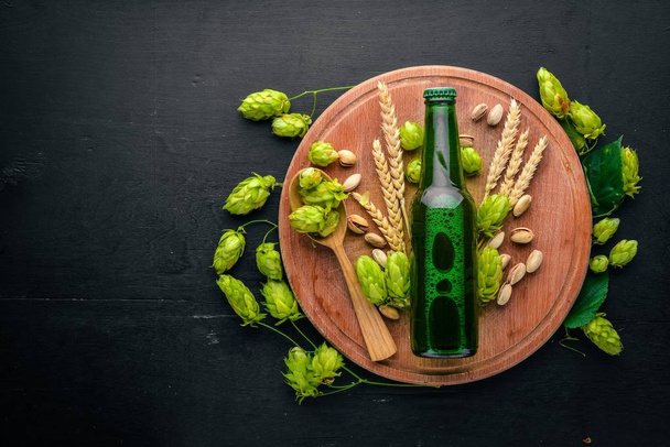 A bottle of beer, hops and grain. Top view. Free space for text. - Foto, Bild