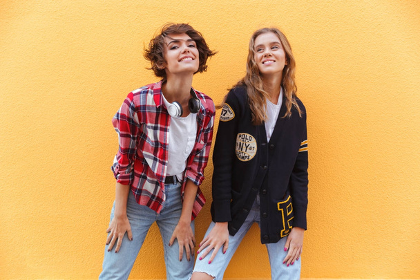 Two cheerful young teenage girls posing - Photo, Image