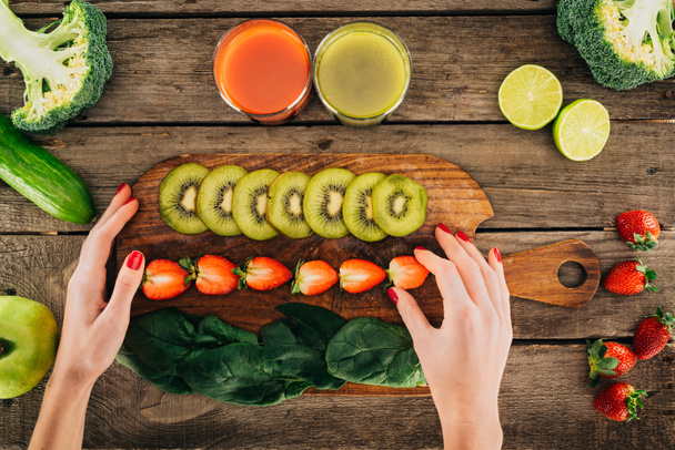 woman and cutting board with fresh vegetables and fruits - Photo, Image