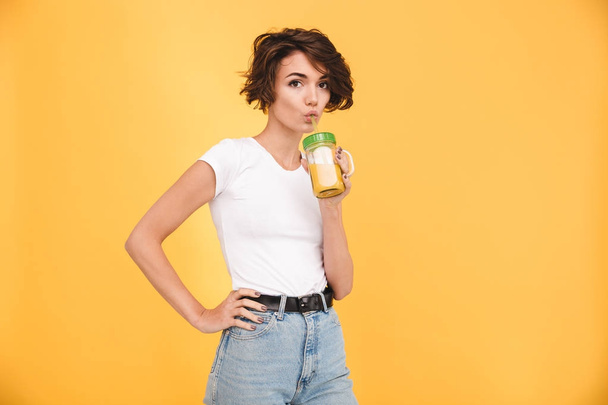Portrait of a lovely casual girl drinking orange juice - Фото, зображення