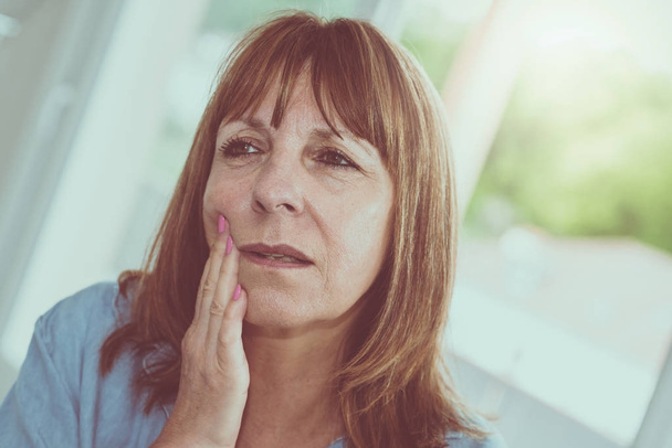 Portrait of mature woman with toothache - Photo, Image
