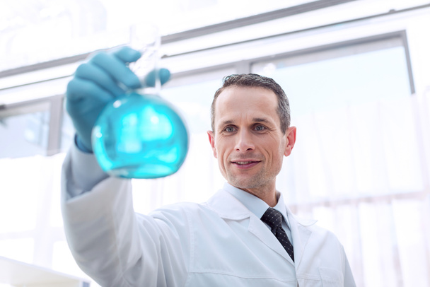 scientist holding flask with reagent - Фото, зображення