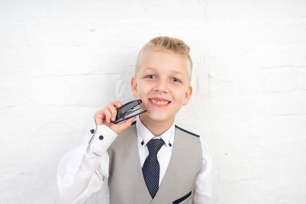  boy holding stapler - Photo, image