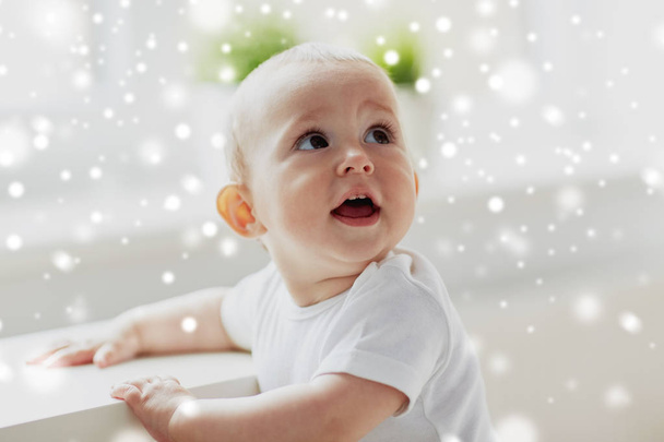 happy little baby boy or girl holding to table - Valokuva, kuva