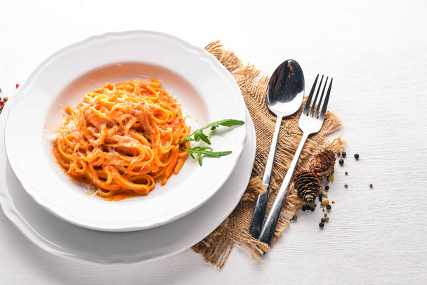 Pasta con pomidorro. On a wooden background. Top view. Free space for text. - Zdjęcie, obraz