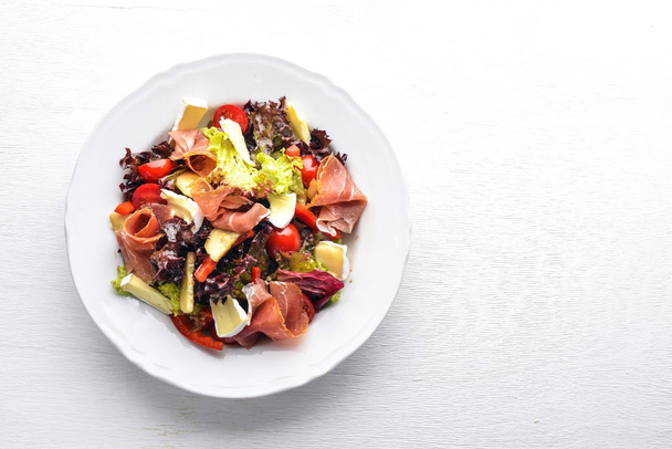 Vegetable salad and diced meat. On a wooden background. Top view. Free space. - Photo, Image