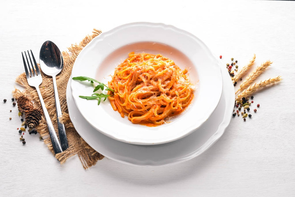 Pasta con pomidorro. On a wooden background. Top view. Free space for text. - Valokuva, kuva