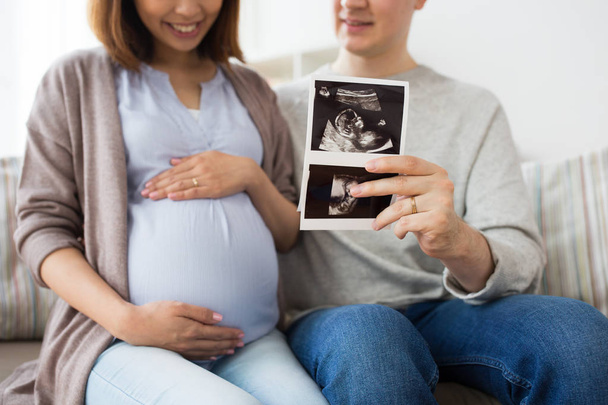 close up of couple with baby ultrasound images - Foto, Imagen