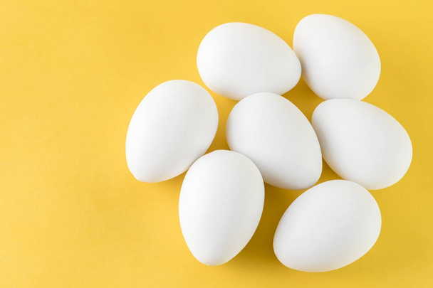  Seven White Hen Eggs Isolated On Yellow Background  - Zdjęcie, obraz