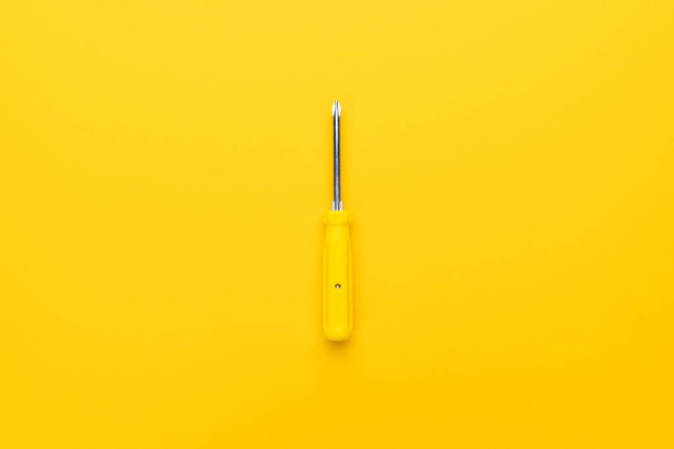 screwdriver on yellow background - Foto, imagen