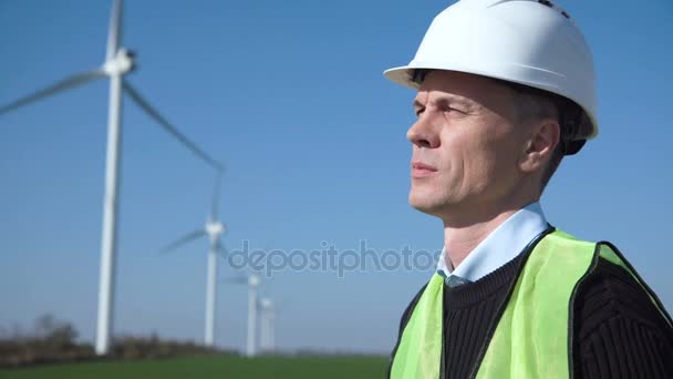 Thoughful engineer against wind turbine - Footage, Video