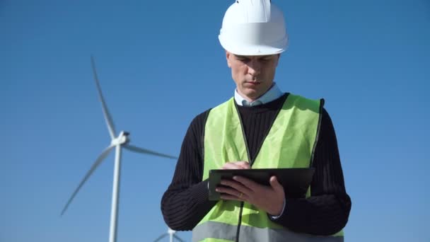 Engineer using digital tablet against wind turbine - Footage, Video