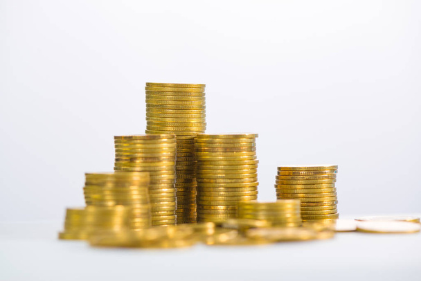 Columns of gold coins, piles of coins on white background - Foto, afbeelding