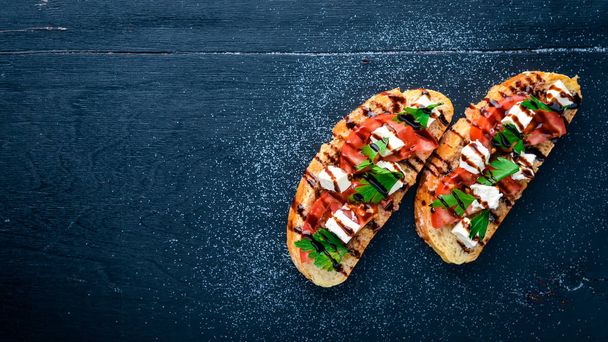 Tomato sandwich and feta cheese. On a wooden background. Top view. Free space for text. - Foto, Imagen