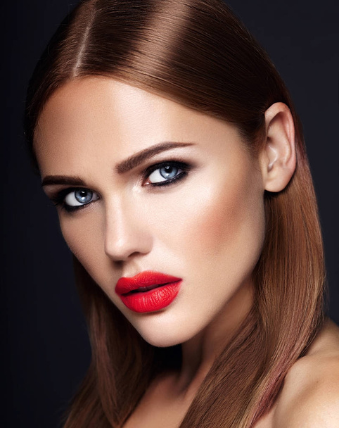 Portrait of beautiful girl model with evening makeup and romantic hairstyle. Red lips - Zdjęcie, obraz