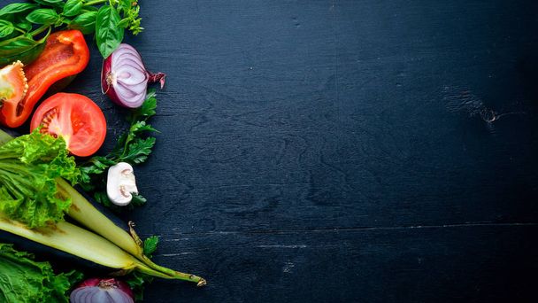 Preparation for cooking, fresh vegetables on a wooden background. Top view. Free space for text. - 写真・画像