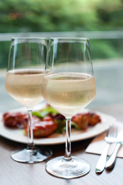 Two glasses of delicious cooled white wine with snack in restaur - Photo, Image