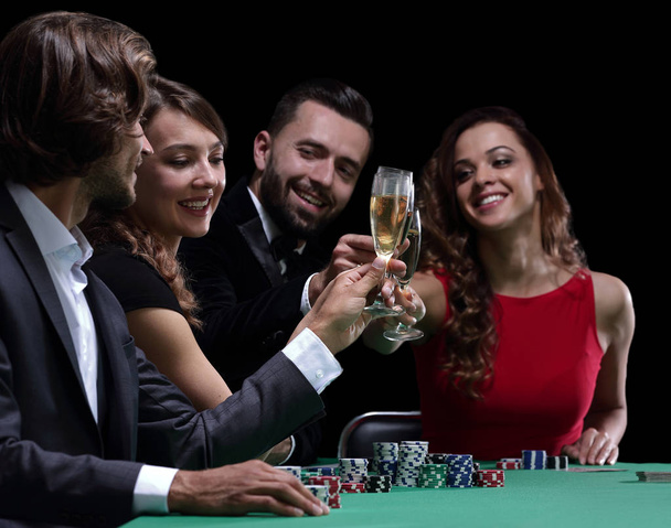 friends drinking and celebrating a gambling night - Фото, изображение
