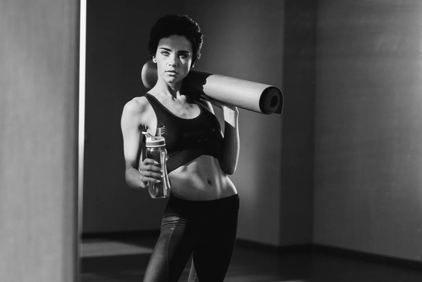 woman with yoga mat and water - Photo, Image